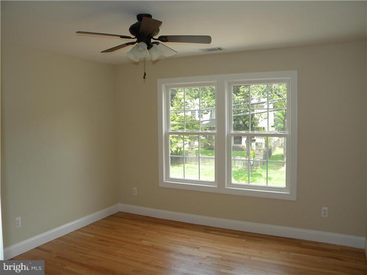 128 Cranbury Road Princeton Junction, NJ 08550 - Photo 18 of 25 a view of an empty room with wooden floor and a window