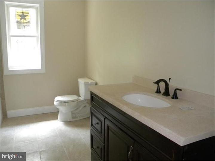 128 Cranbury Road Princeton Junction, NJ 08550 - Photo 19 of 25 a bathroom with a granite countertop sink and a toilet