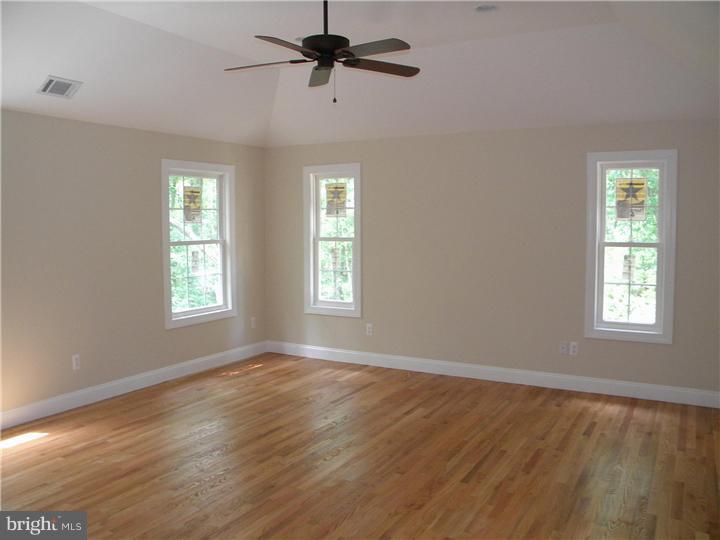 128 Cranbury Road Princeton Junction, NJ 08550 - Photo 20 of 25 a view of empty room with wooden floor and fan