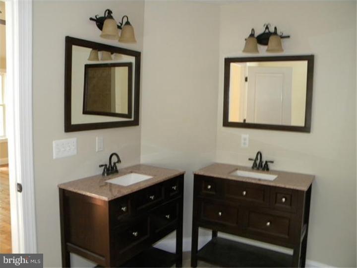 128 Cranbury Road Princeton Junction, NJ 08550 - Photo 21 of 25 a bathroom with a toilet sink and mirror