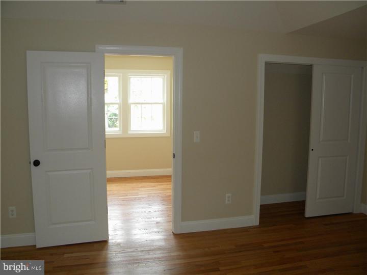 128 Cranbury Road Princeton Junction, NJ 08550 - Photo 23 of 25 a view of empty room with wooden floor and fan