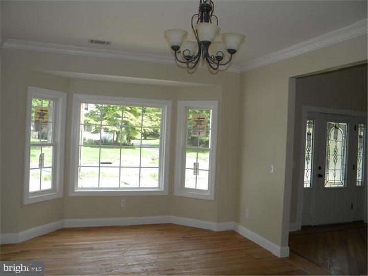 128 Cranbury Road Princeton Junction, NJ 08550 - Photo 4 of 25 a view of empty room with wooden floor and fan