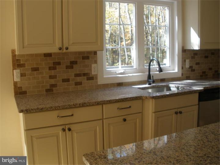 128 Cranbury Road Princeton Junction, NJ 08550 - Photo 6 of 25 a kitchen with granite countertop a sink a window and a granite counter tops