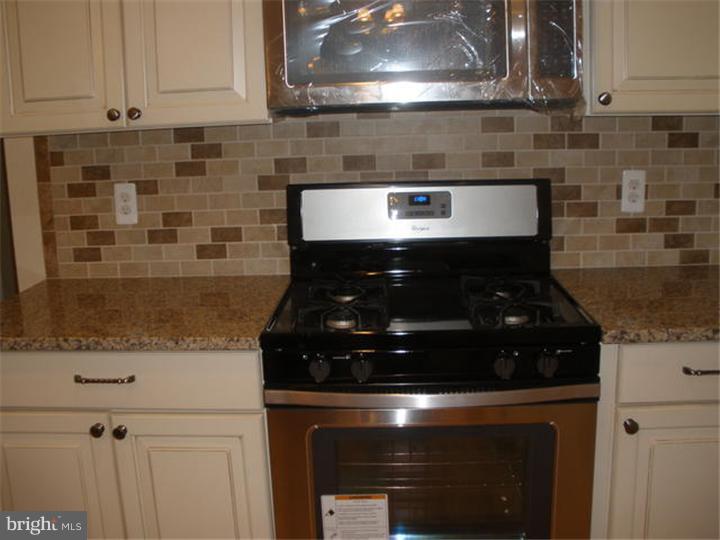 128 Cranbury Road Princeton Junction, NJ 08550 - Photo 7 of 25 a stove top oven sitting inside of a kitchen
