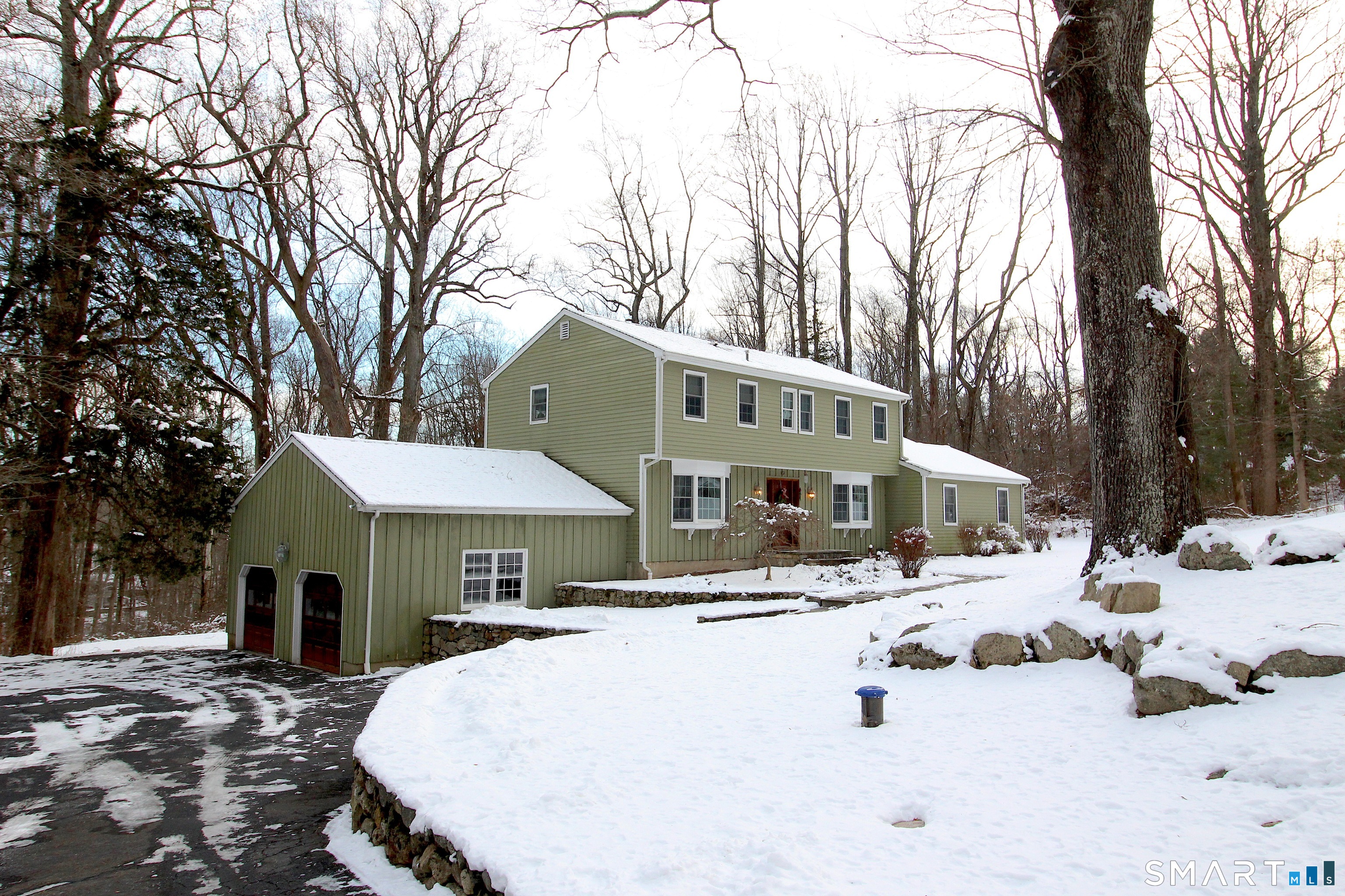 a view of a house with a yard covered in snow