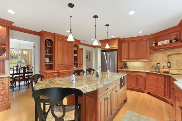 a kitchen with center island table and chairs