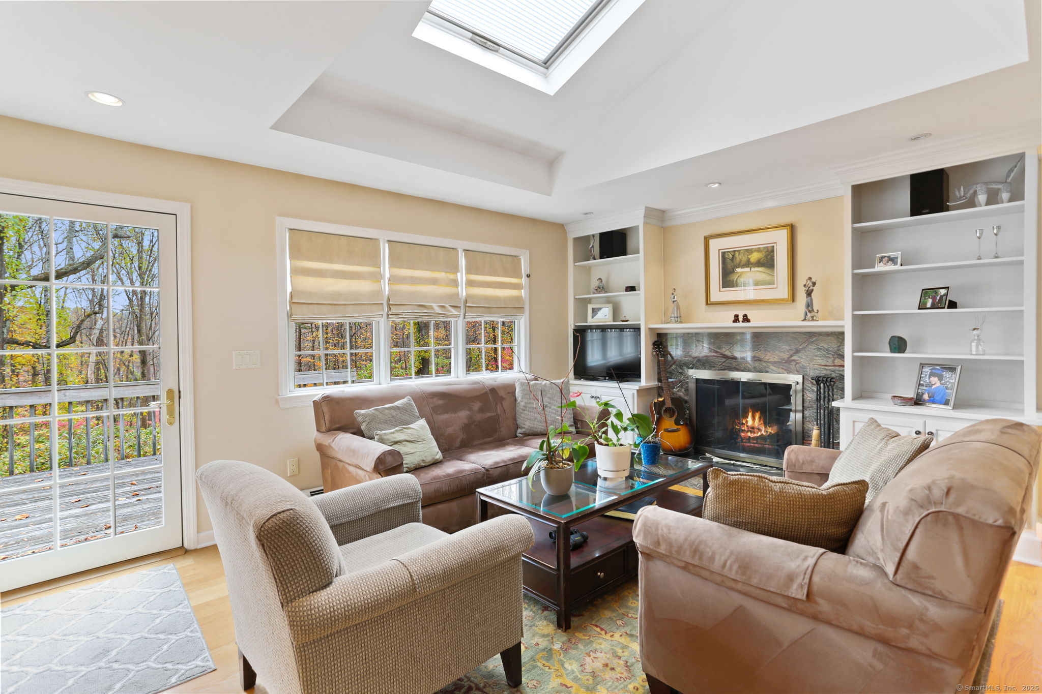 41 Calvin Road Wilton, CT 06897 - Photo 14 of 34 a living room with furniture a fireplace and a large window