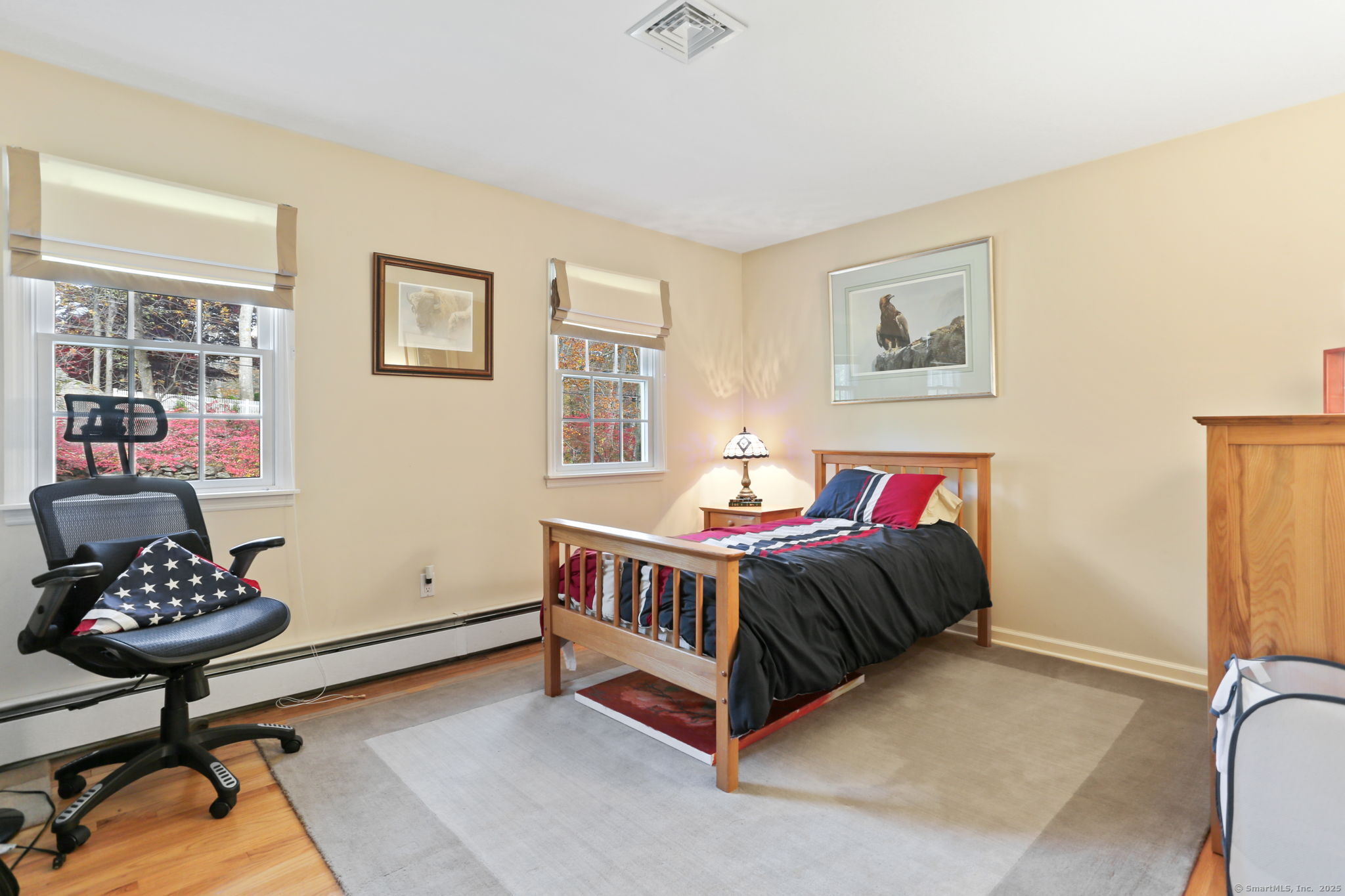 41 Calvin Road Wilton, CT 06897 - Photo 20 of 34 a bedroom with a bed and a chandelier