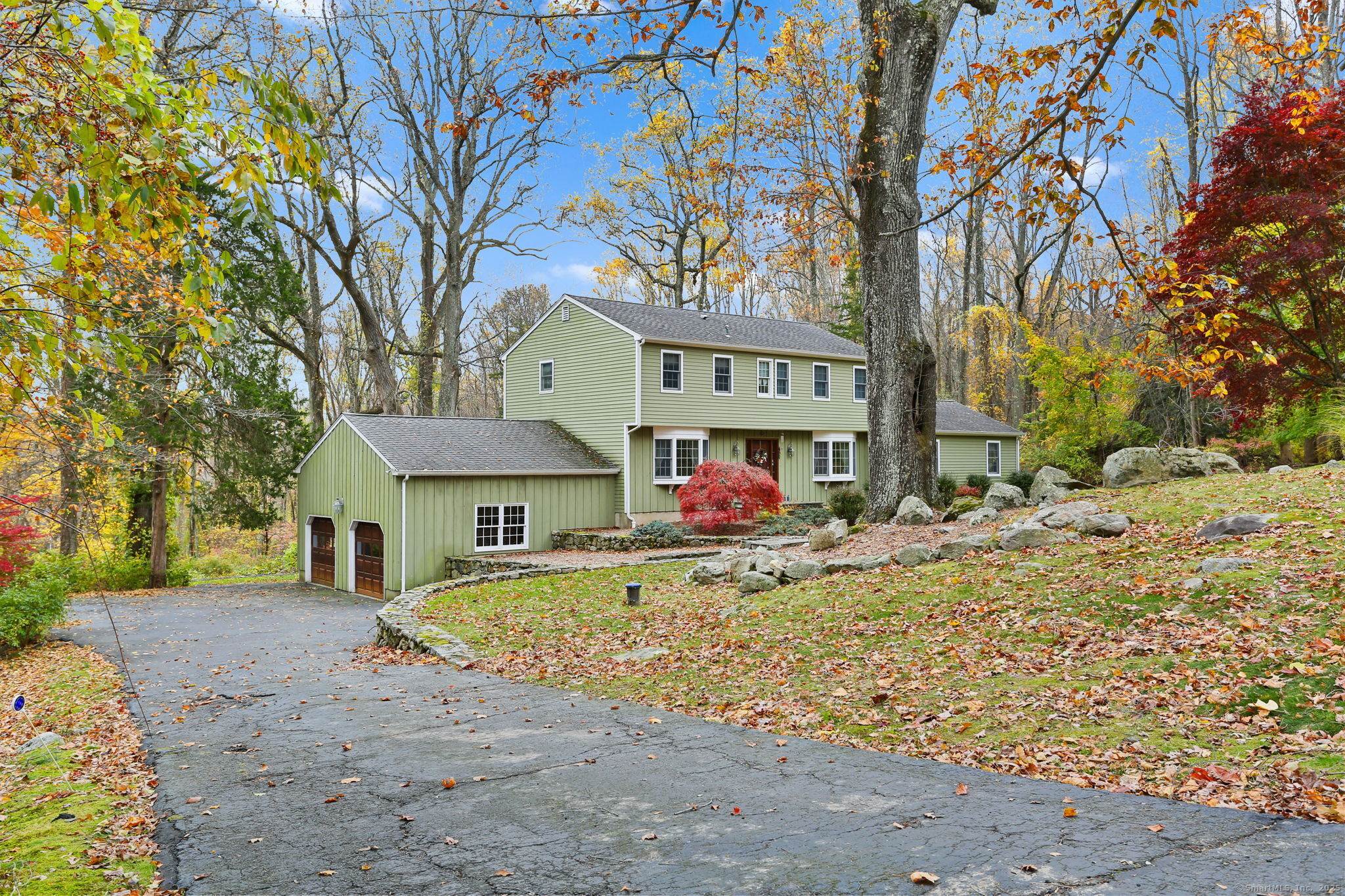 41 Calvin Road Wilton, CT 06897 - Photo 2 of 34 a front view of a house with a yard covered with snow