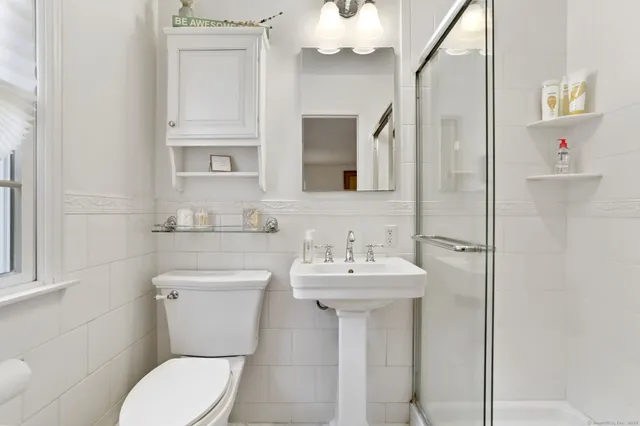 a bathroom with a sink a toilet and mirror