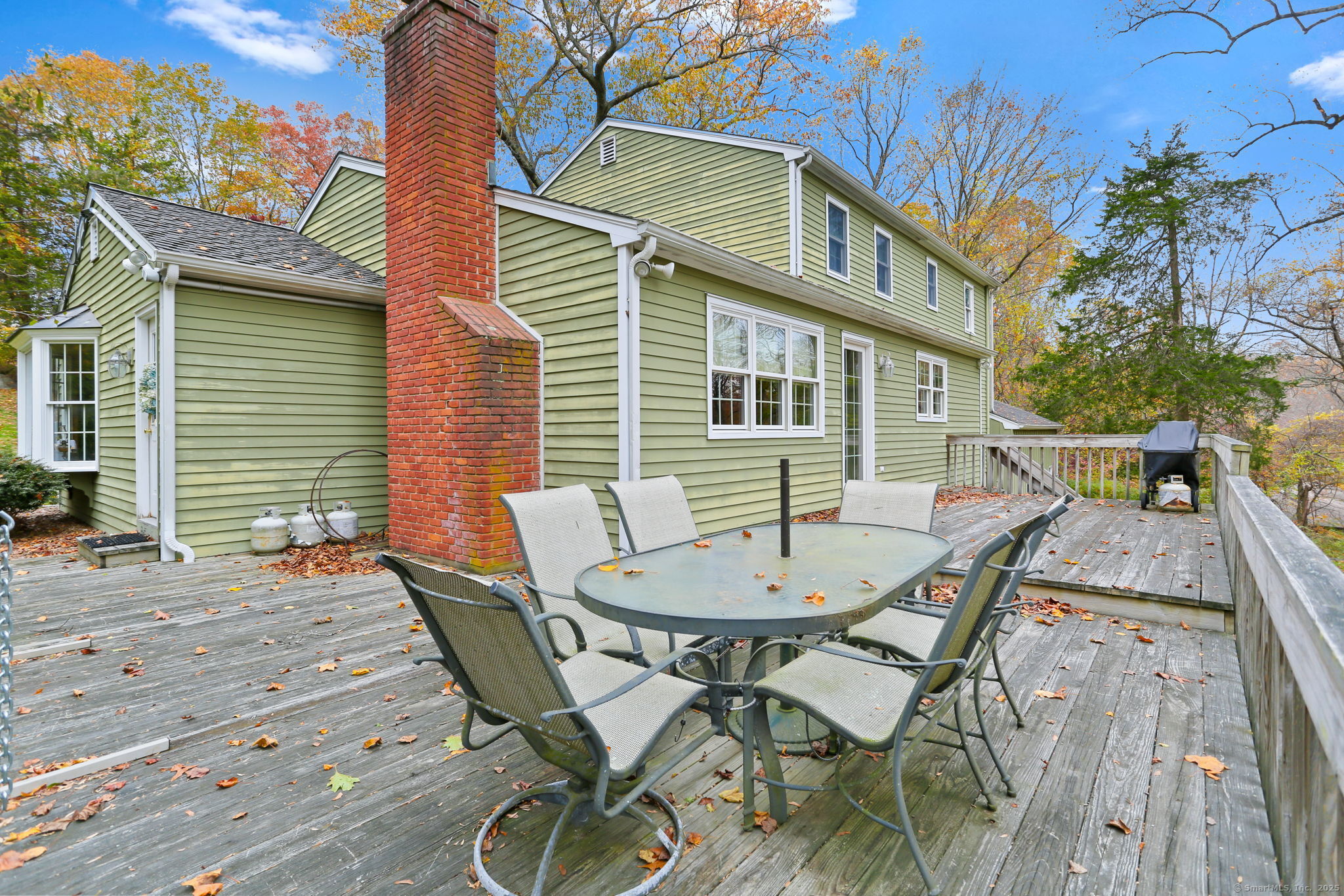 41 Calvin Road Wilton, CT 06897 - Photo 28 of 34 a view of a patio with table and chairs and potted plants