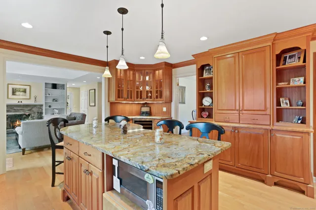 a kitchen with stainless steel appliances granite countertop stove top oven and cabinets