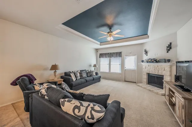 a living room with furniture a fireplace and a flat screen tv