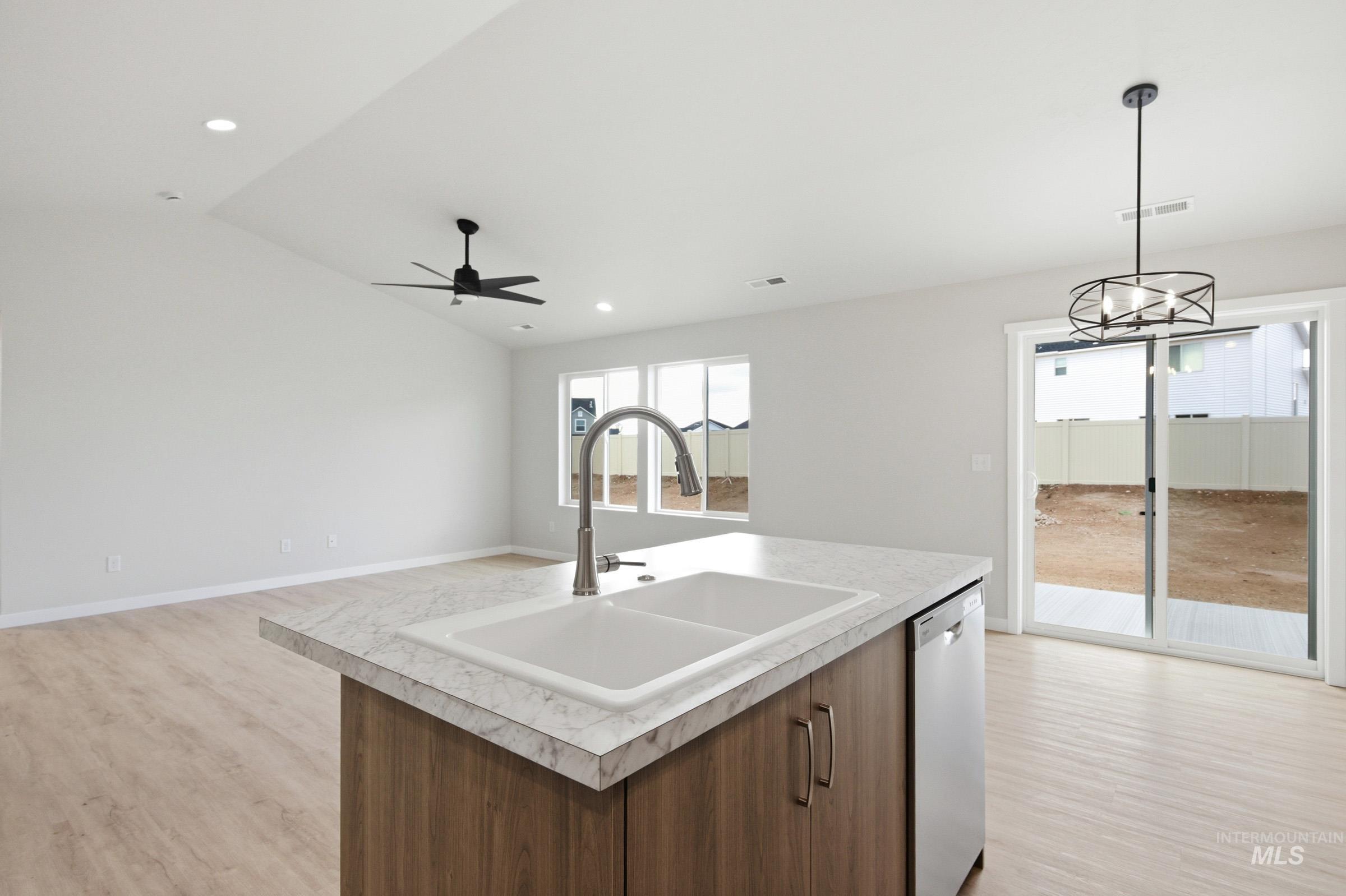 16632 North Shorthorn Loop Nampa, ID 83651 - Photo 9 of 17 Kitchen island with double basin sink, stainless steel faucet, and dishwasher