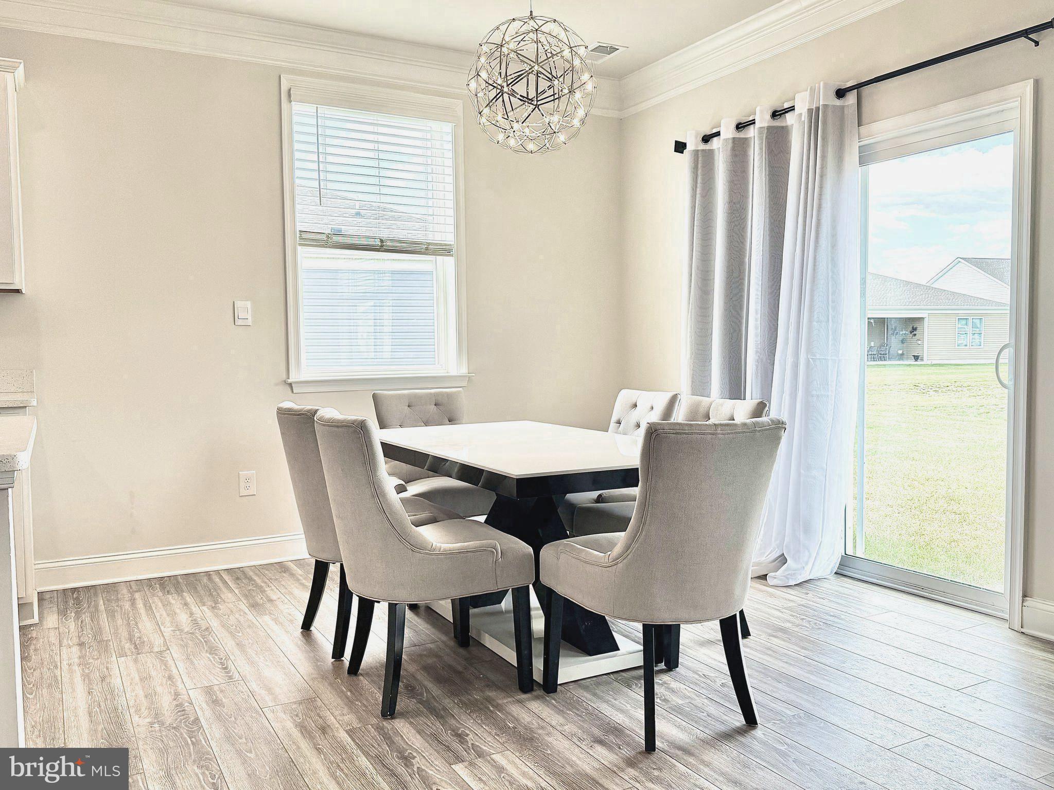 31131 Tigress Road Lewes, DE 19958 - Photo 11 of 45 a view of a dining room with furniture window and wooden floor