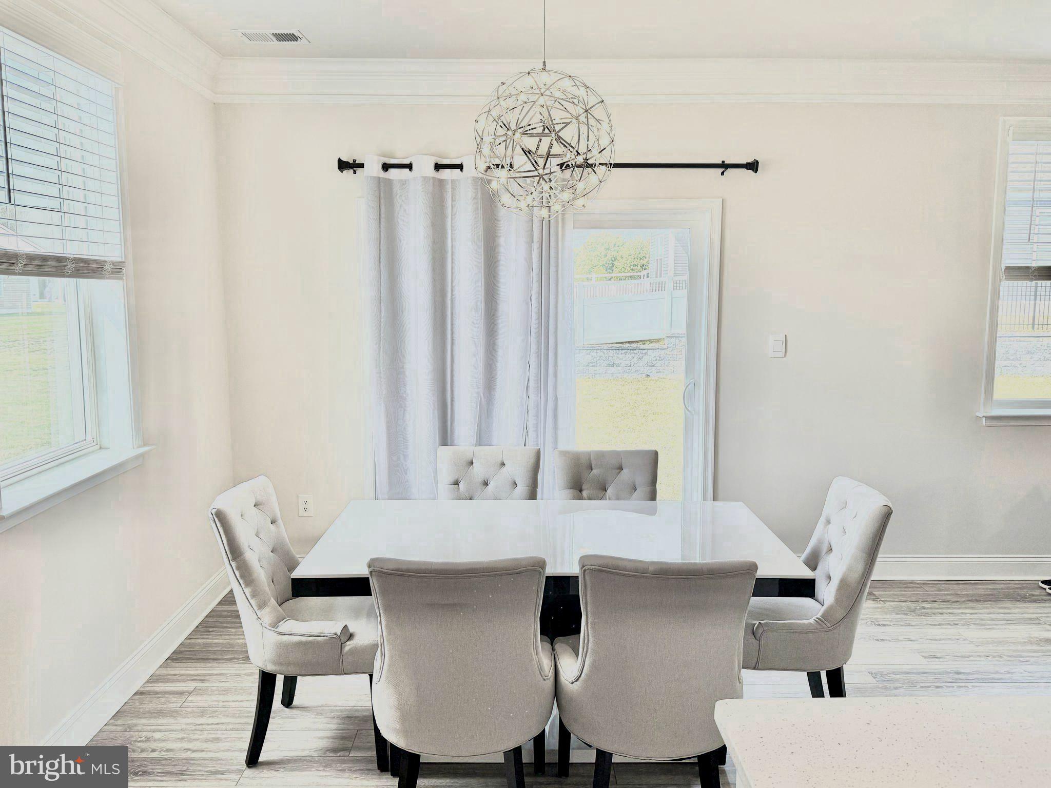 31131 Tigress Road Lewes, DE 19958 - Photo 13 of 45 a view of a dining room with furniture and chandelier