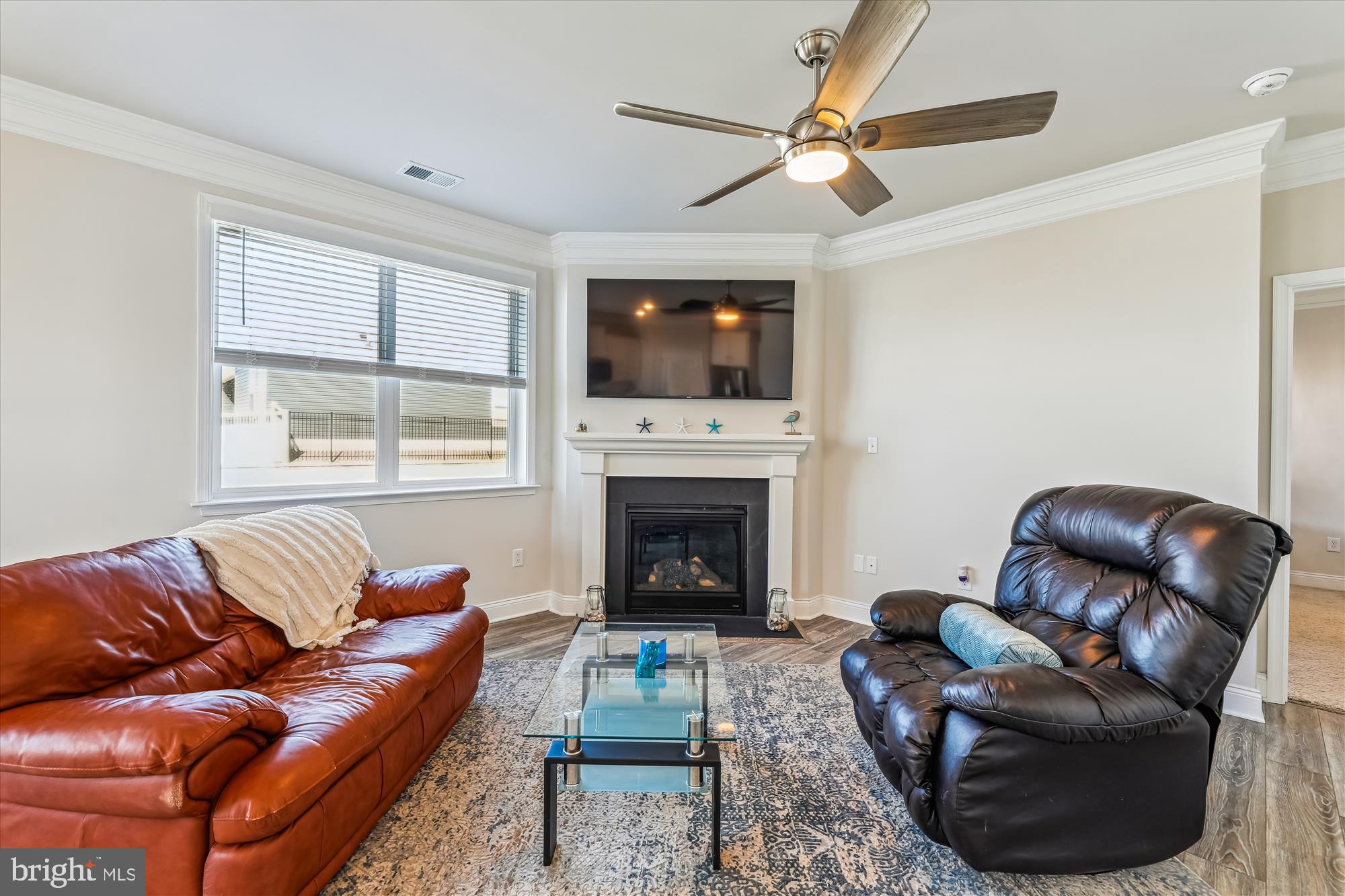 31131 Tigress Road Lewes, DE 19958 - Photo 14 of 45 a living room with furniture a flat screen tv and a fireplace