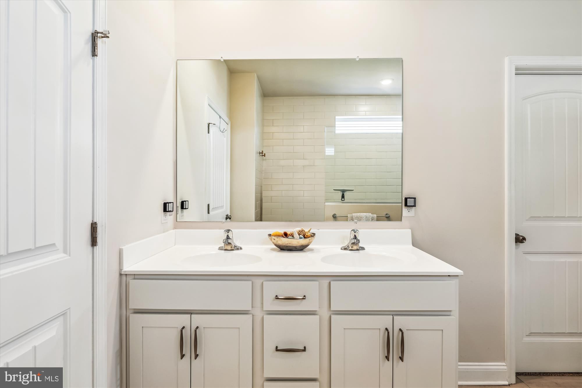 31131 Tigress Road Lewes, DE 19958 - Photo 19 of 45 a bathroom with a sink and a mirror