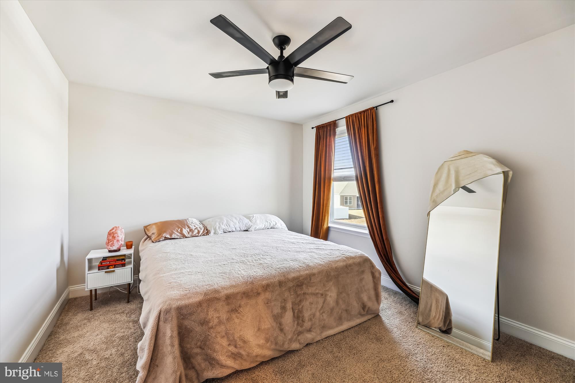31131 Tigress Road Lewes, DE 19958 - Photo 26 of 45 a bedroom with a bed a window and a ceiling fan