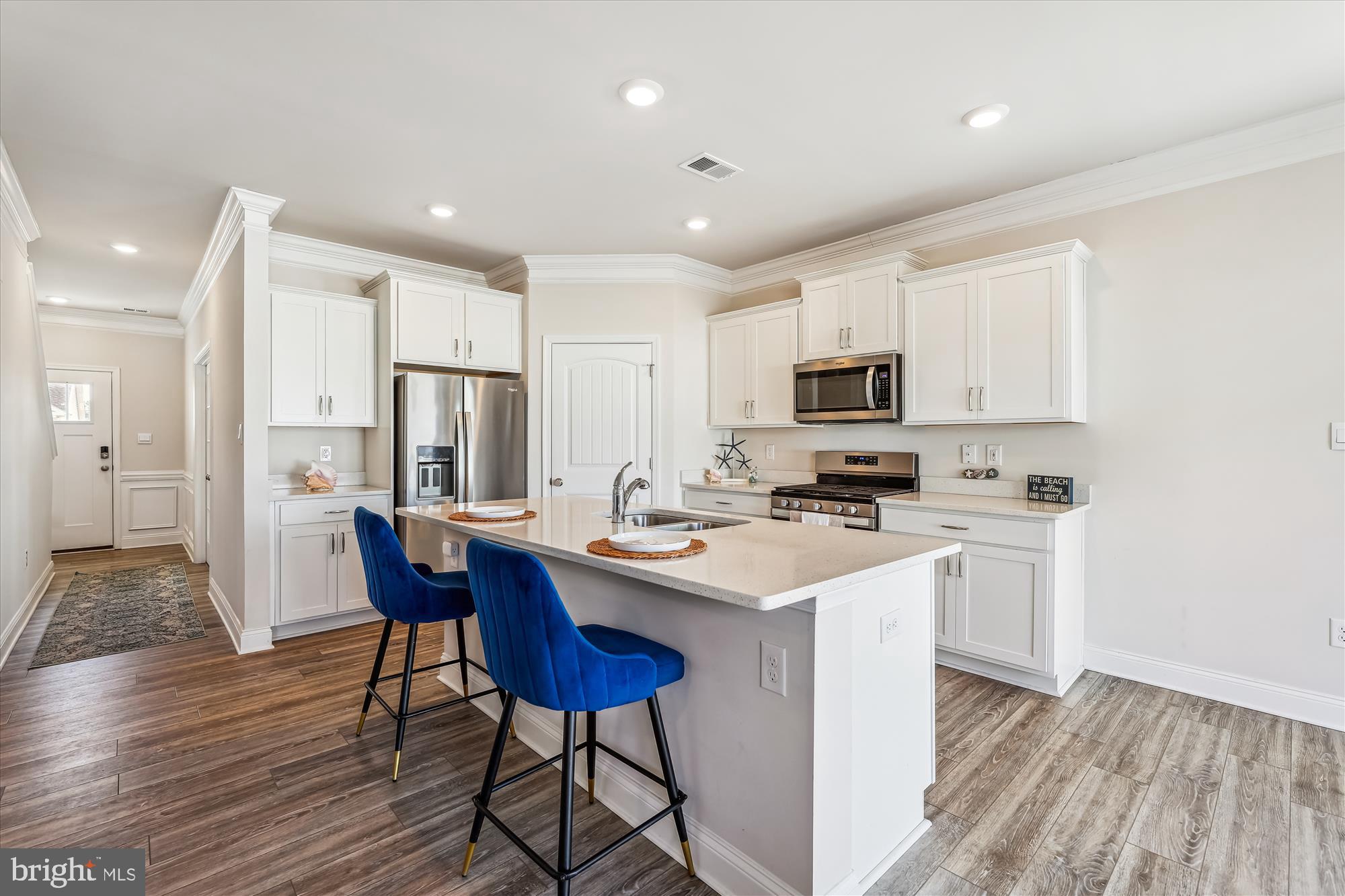 31131 Tigress Road Lewes, DE 19958 - Photo 7 of 45 a kitchen with a sink stainless steel appliances and white cabinets