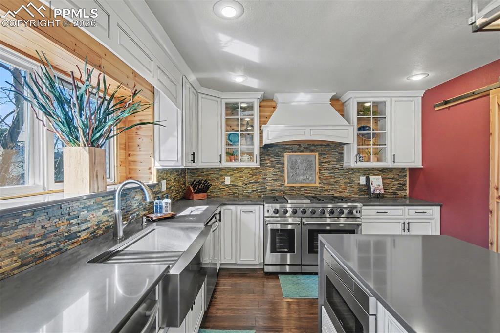 1375 Blueberry Hills Road Monument, CO 80132 - Photo 12 of 50 a kitchen with stainless steel appliances granite countertop a stove and a sink