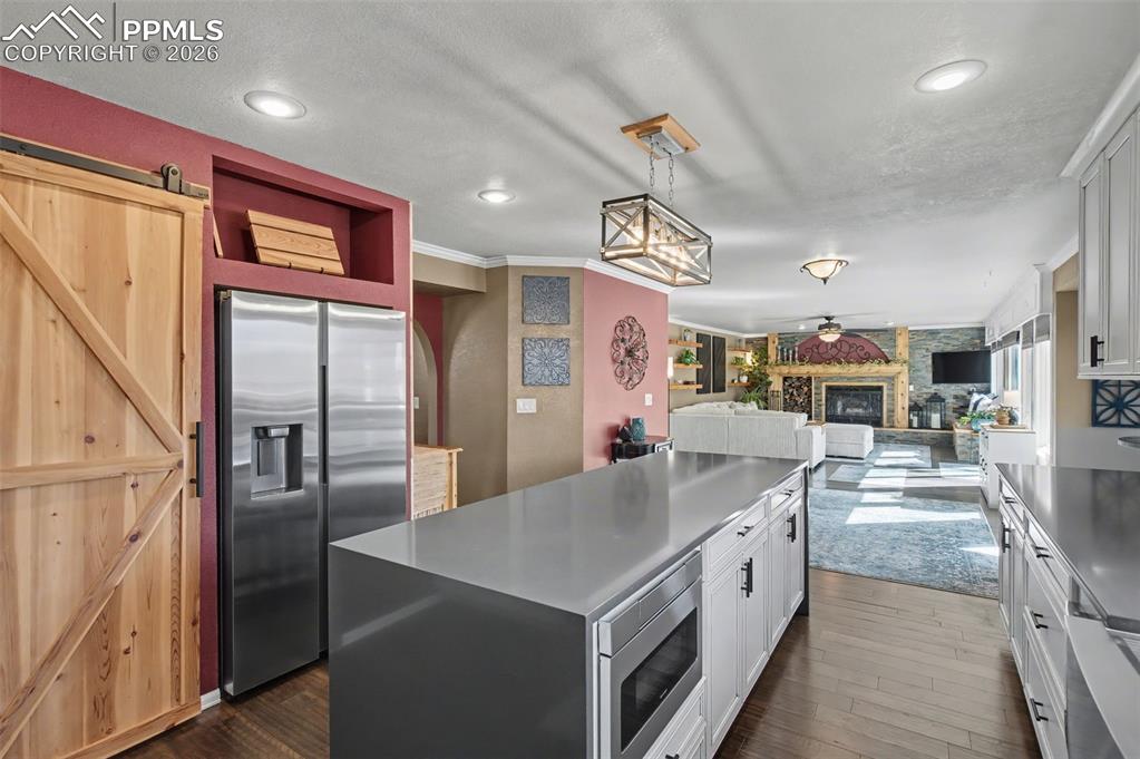 1375 Blueberry Hills Road Monument, CO 80132 - Photo 15 of 50 a kitchen with stainless steel appliances granite countertop a sink and a refrigerator