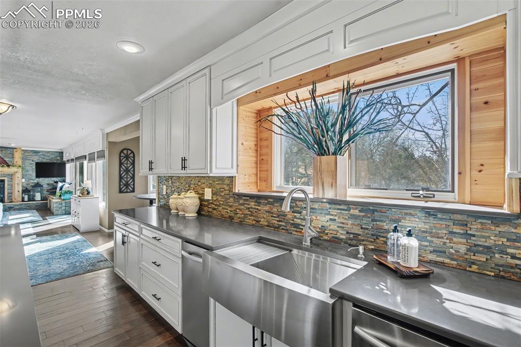 1375 Blueberry Hills Road Monument, CO 80132 - Photo 16 of 50 a kitchen with stainless steel appliances a sink a stove and a window
