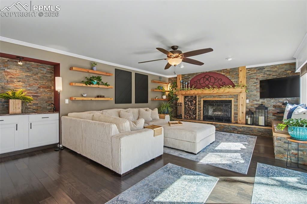 1375 Blueberry Hills Road Monument, CO 80132 - Photo 18 of 50 a living room with furniture a fireplace and a flat screen tv