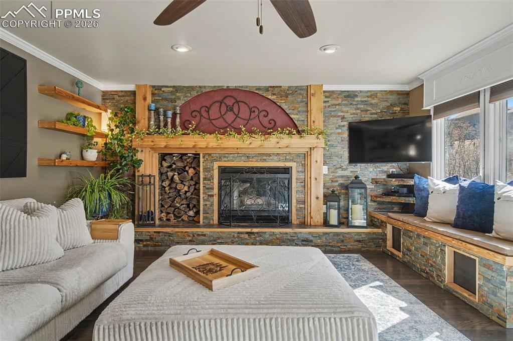 1375 Blueberry Hills Road Monument, CO 80132 - Photo 19 of 50 a living room with furniture a flat screen tv and a fireplace