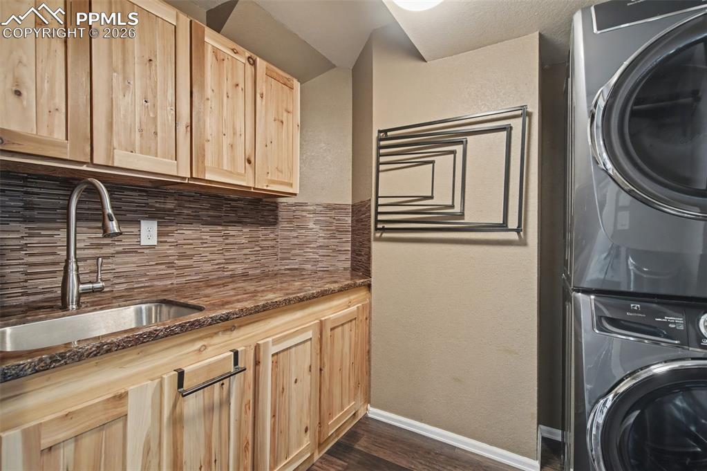 1375 Blueberry Hills Road Monument, CO 80132 - Photo 24 of 50 a kitchen with granite countertop cabinets washer and dryer