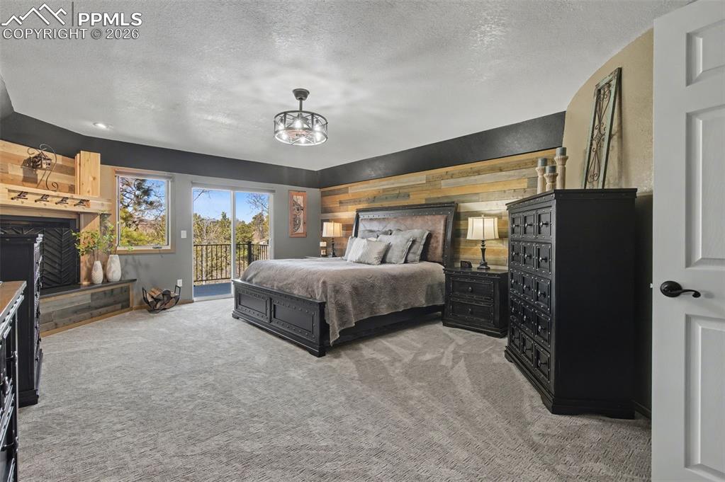 1375 Blueberry Hills Road Monument, CO 80132 - Photo 26 of 50 a bedroom with a bed couch and a large window