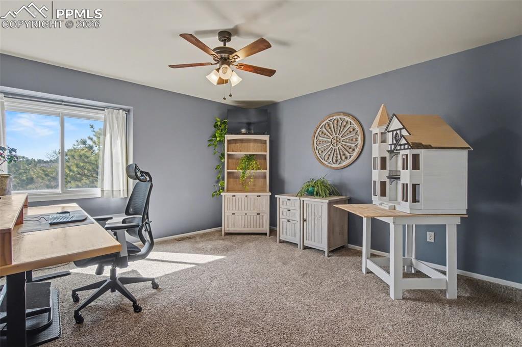 1375 Blueberry Hills Road Monument, CO 80132 - Photo 32 of 50 a view of a workspace with furniture and a window
