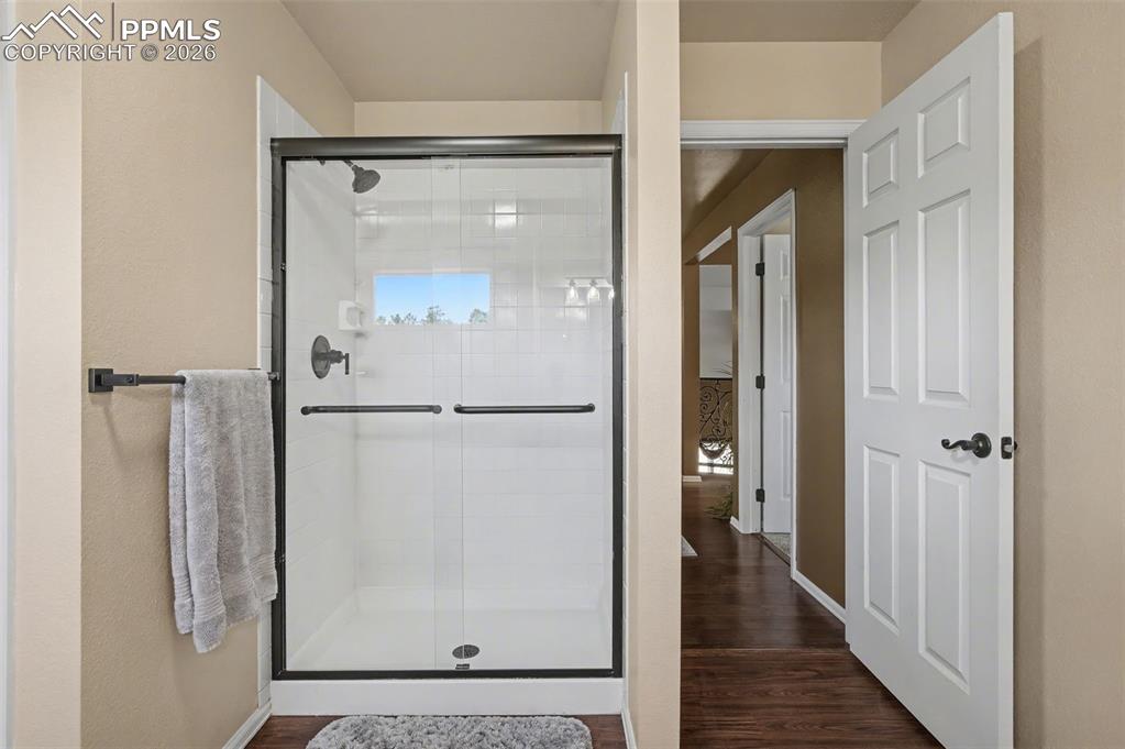 1375 Blueberry Hills Road Monument, CO 80132 - Photo 34 of 50 a bathroom with a glass shower door