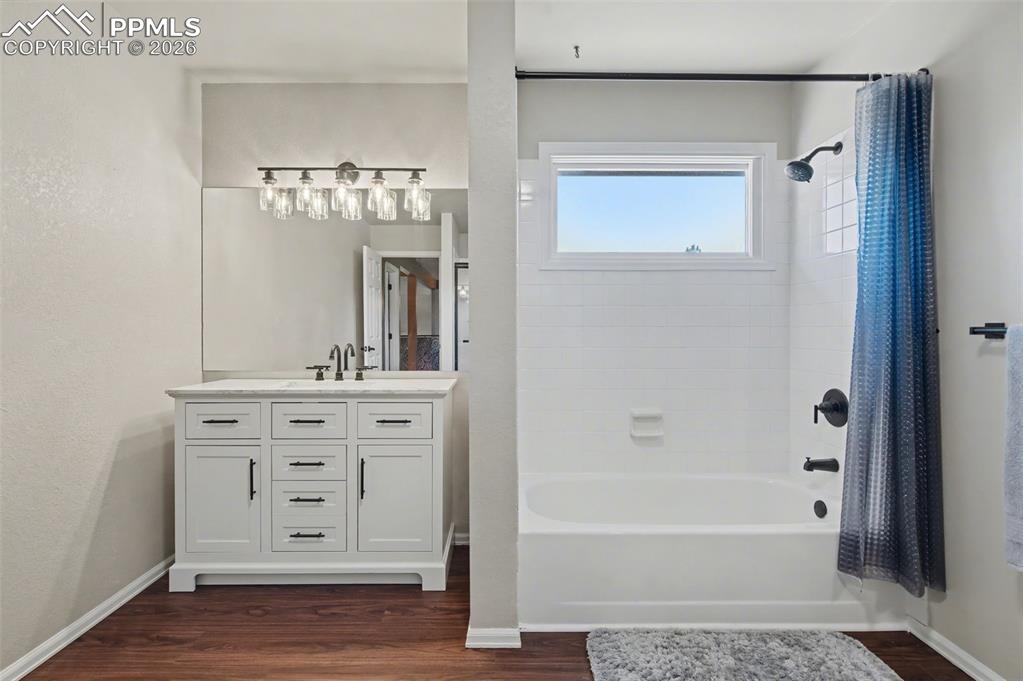 1375 Blueberry Hills Road Monument, CO 80132 - Photo 35 of 50 a bathroom with a sink a mirror and a bathtub