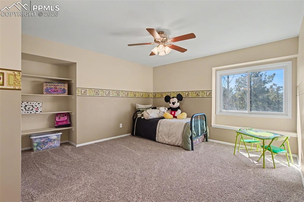 1375 Blueberry Hills Road Monument, CO 80132 - Photo 36 of 50 a bed room with a bed and a window