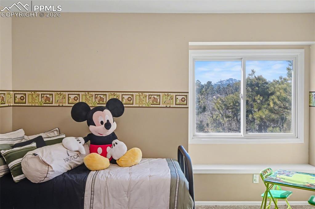 1375 Blueberry Hills Road Monument, CO 80132 - Photo 38 of 50 a bed sitting in a bedroom next to a window