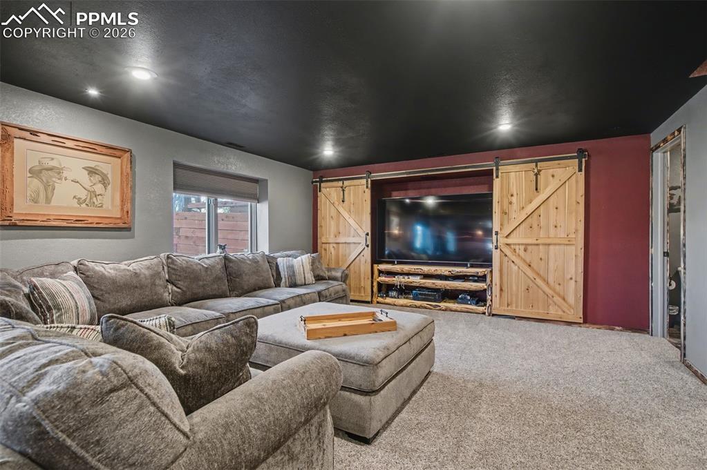 1375 Blueberry Hills Road Monument, CO 80132 - Photo 40 of 50 a living room with furniture and a flat screen tv