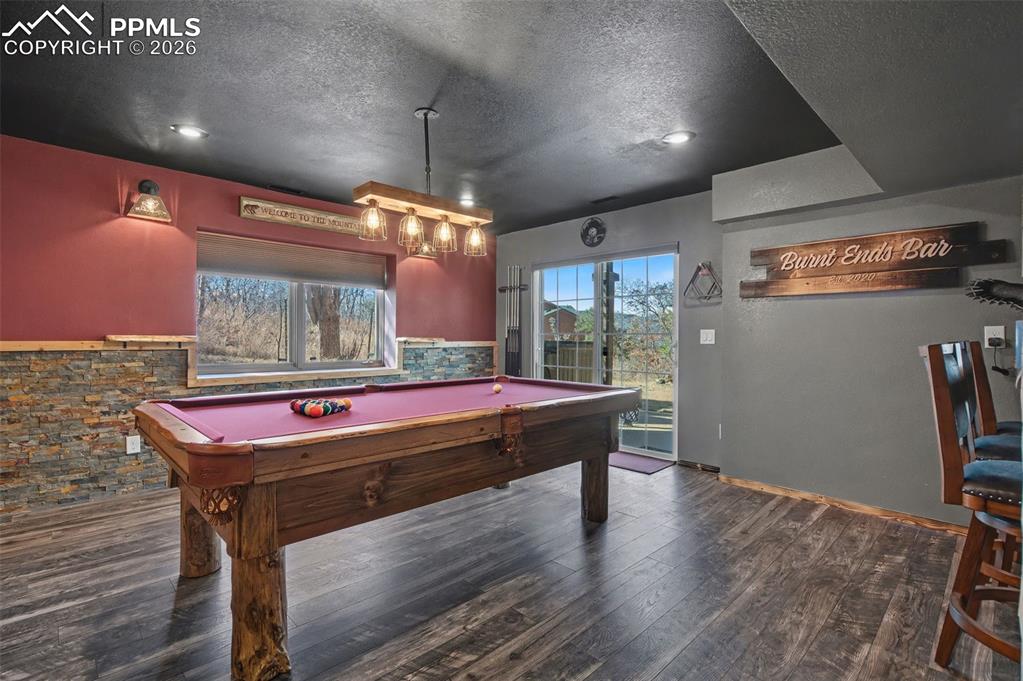 1375 Blueberry Hills Road Monument, CO 80132 - Photo 42 of 50 a room with pool table wooden floor and windows