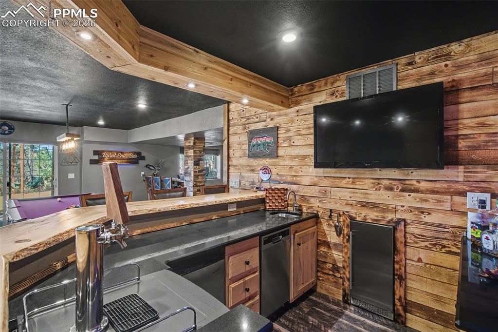 1375 Blueberry Hills Road Monument, CO 80132 - Photo 45 of 50 a view of a kitchen with furniture and a flat screen tv