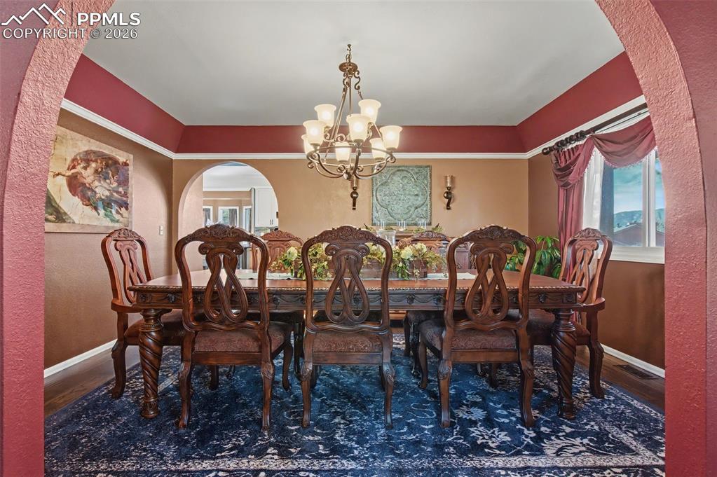 1375 Blueberry Hills Road Monument, CO 80132 - Photo 10 of 50 a view of a dining room with furniture and chandelier