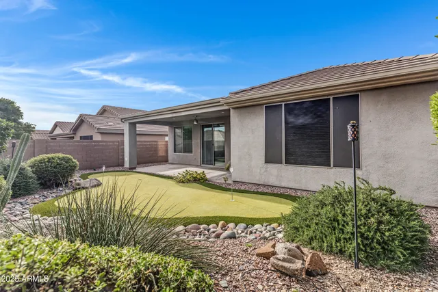a view of a house with pool and sitting area