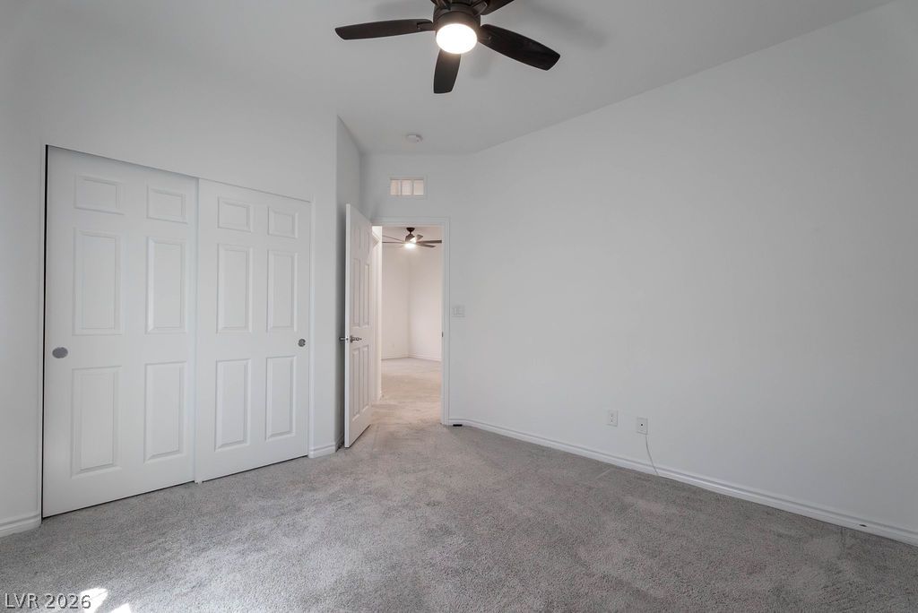 7126 Calvert Cliffs Street North Las Vegas, NV 89084 - Photo 32 of 44 A well-lit bedroom with fresh, neutral tones and soft carpeting offers a comfortable living space.