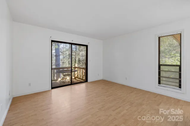 an empty room with windows and closet