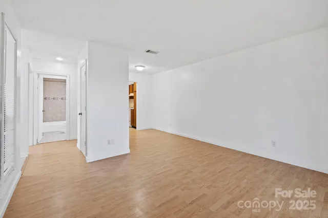 a hallway with a window and a bathroom