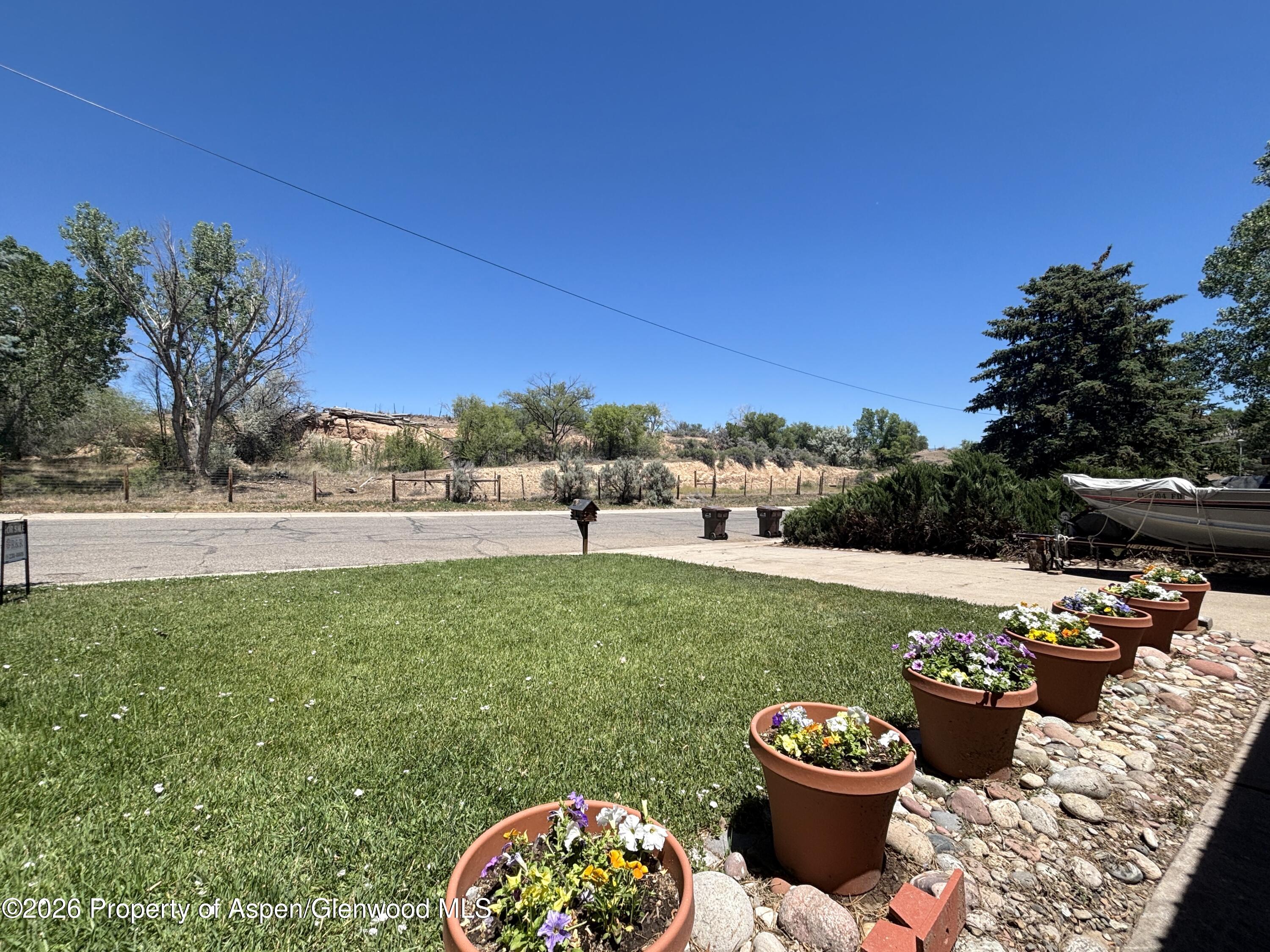 1623 West 7th Street Rifle, CO 81650 - Photo 2 of 21 a view of a backyard with garden and plants