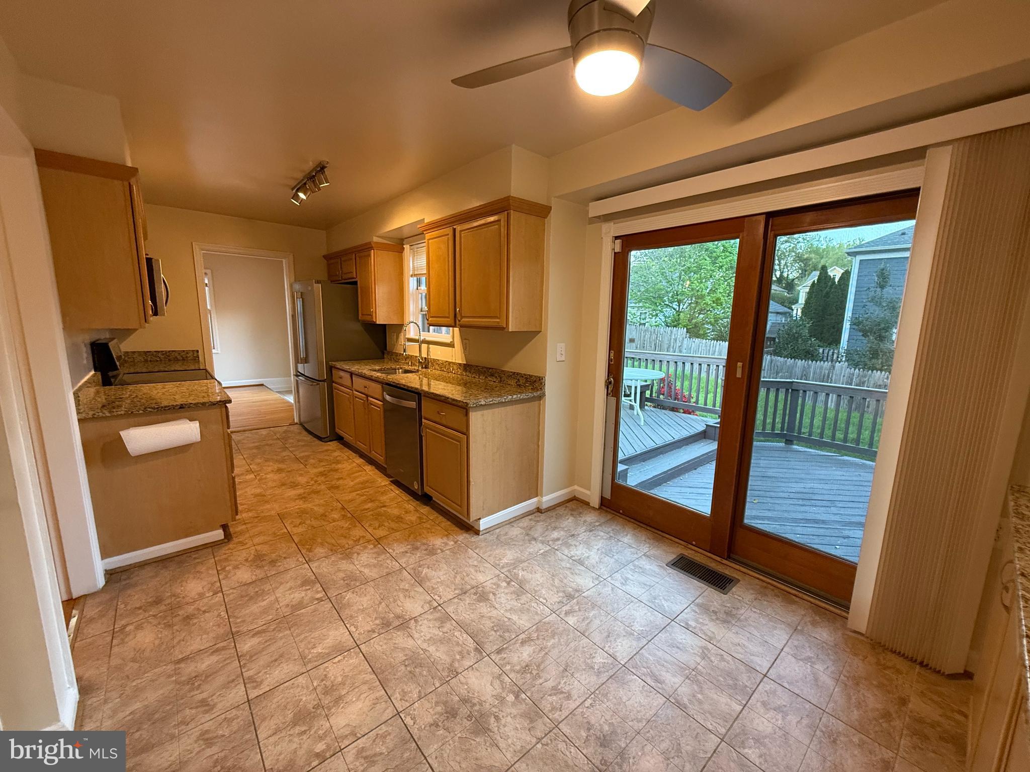 6209 Redwing Road Bethesda, MD 20817 - Photo 11 of 27 a kitchen with stainless steel appliances granite countertop a refrigerator and a sink