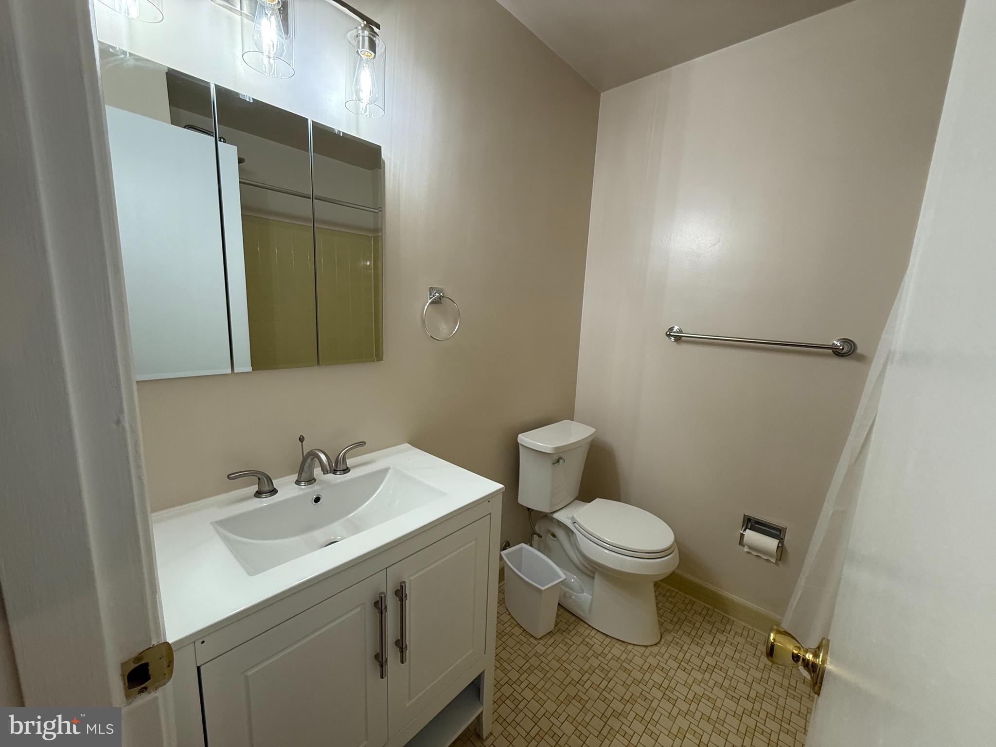 6209 Redwing Road Bethesda, MD 20817 - Photo 18 of 27 a bathroom with a sink toilet and a mirror