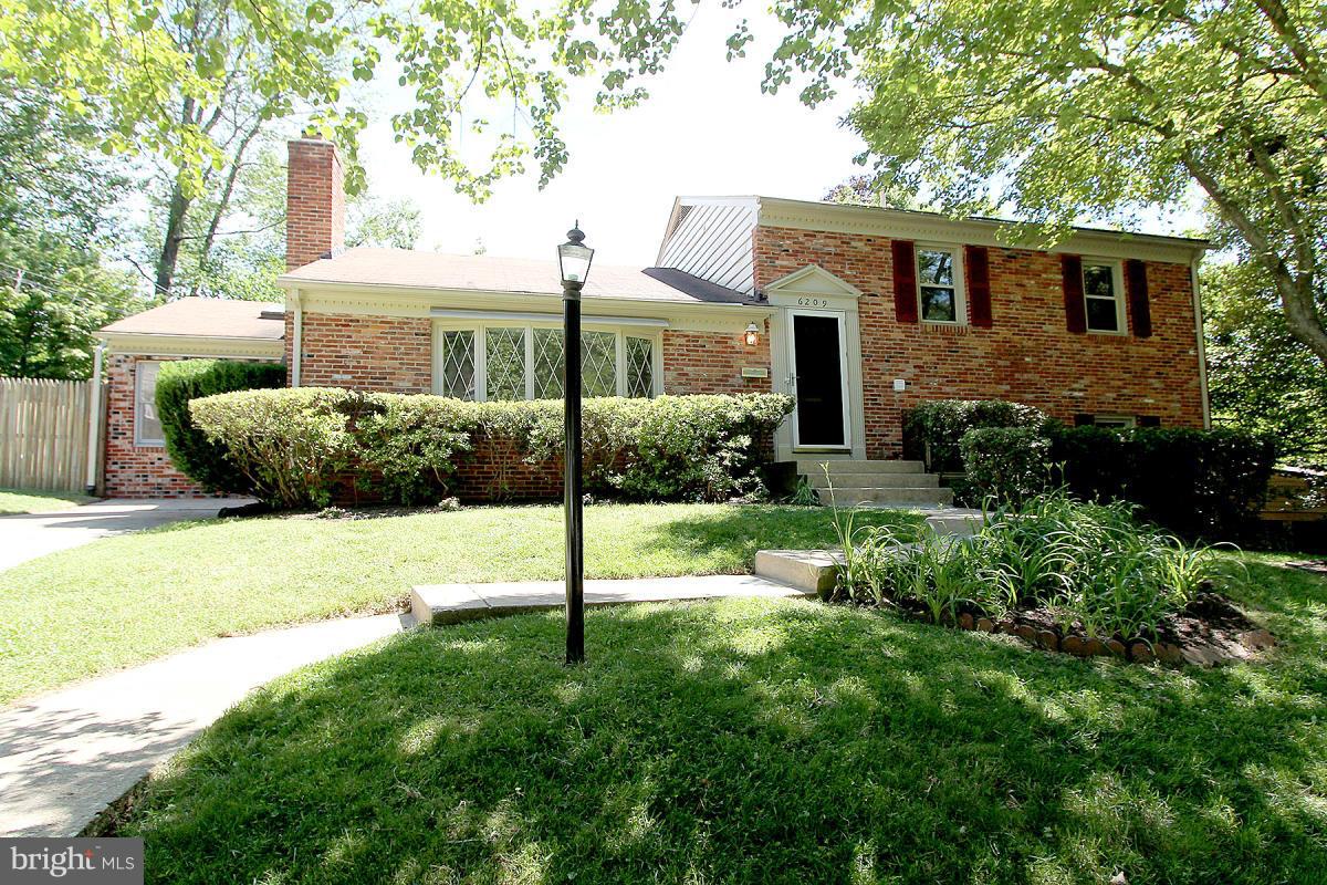 6209 Redwing Road Bethesda, MD 20817 - Photo 2 of 27 a front view of a house with a yard
