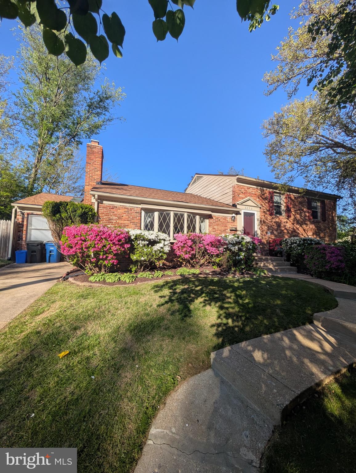 6209 Redwing Road Bethesda, MD 20817 - Photo 27 of 27 a flower garden is sitting in front of a house