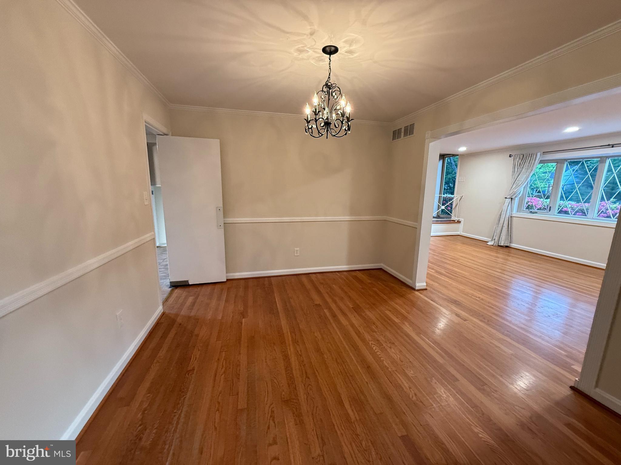 6209 Redwing Road Bethesda, MD 20817 - Photo 6 of 27 wooden floor in an empty room with a window